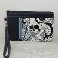 Load image into Gallery viewer, Skull zippy clutch with detachable wristlet strap and credit card organizer.
