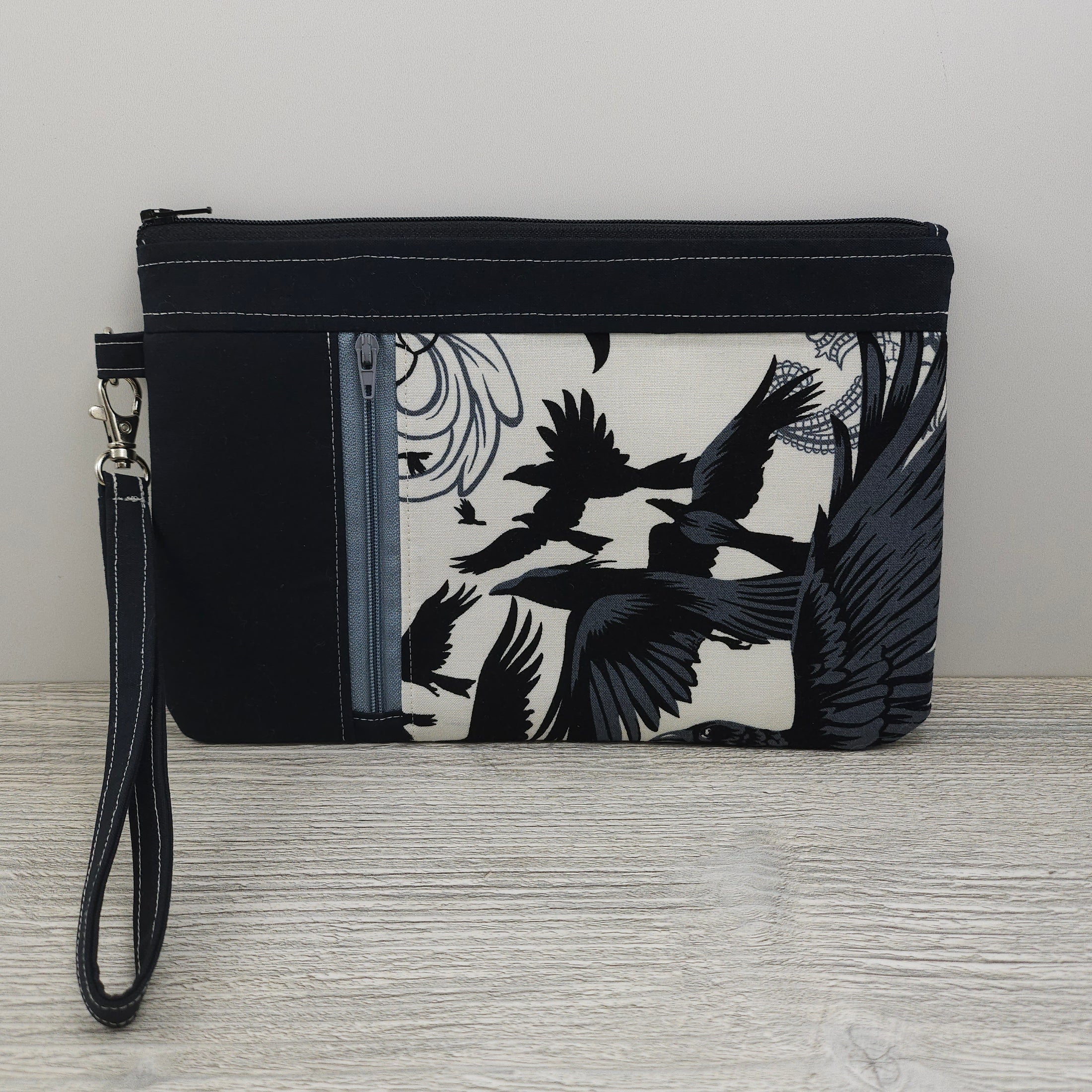 Crows zippy clutch with detachable wristlet strap and credit card organizer. 