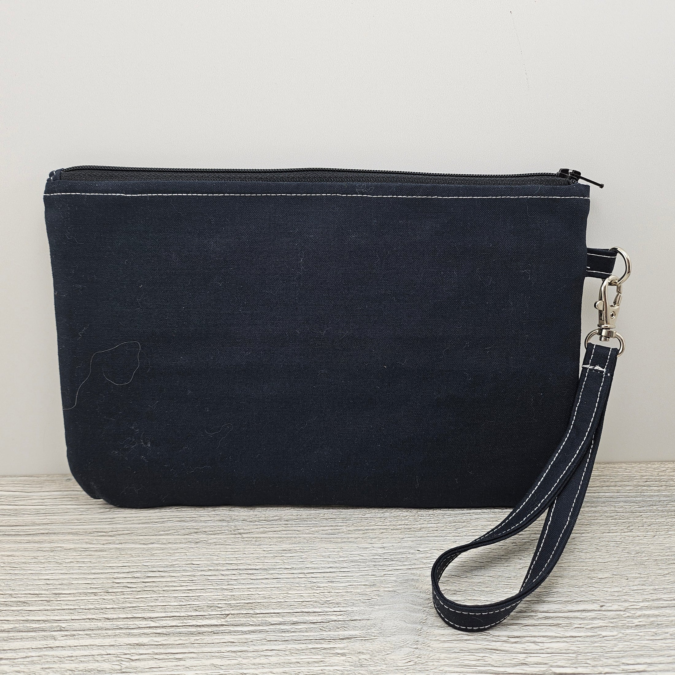 Black back on the cameo zippy clutch.