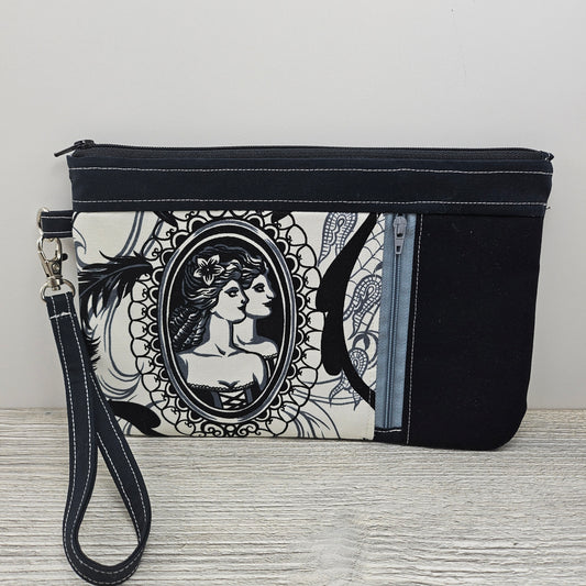 Cameo zippy clutch with detachable wristlet strap and credit card organizer.