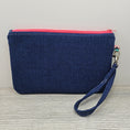 Load image into Gallery viewer, Blue back, pink zipper and detachable wristlet strap. 
