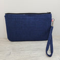 Load image into Gallery viewer, Blue back, black zipper and detachable wristlet strap.
