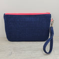 Load image into Gallery viewer, Blue back, pink zipper and blue detachable wristlet strap. 
