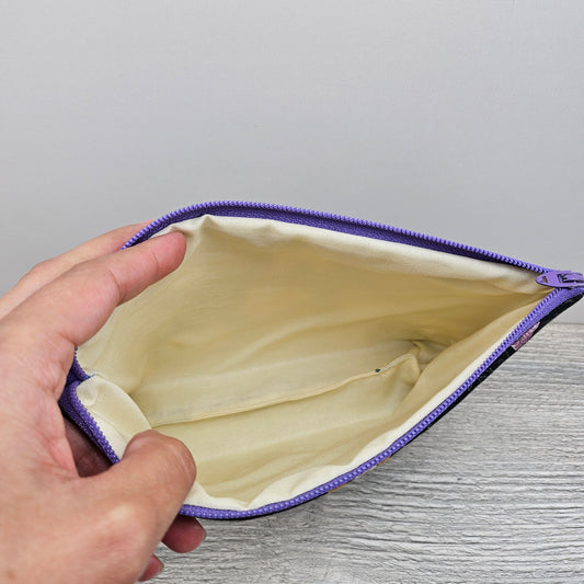 Hocus Pocus inspired zipper pouch with cream interior and purple zipper. 