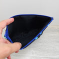 Load image into Gallery viewer, Black interior of outer space themed makeup pouch.
