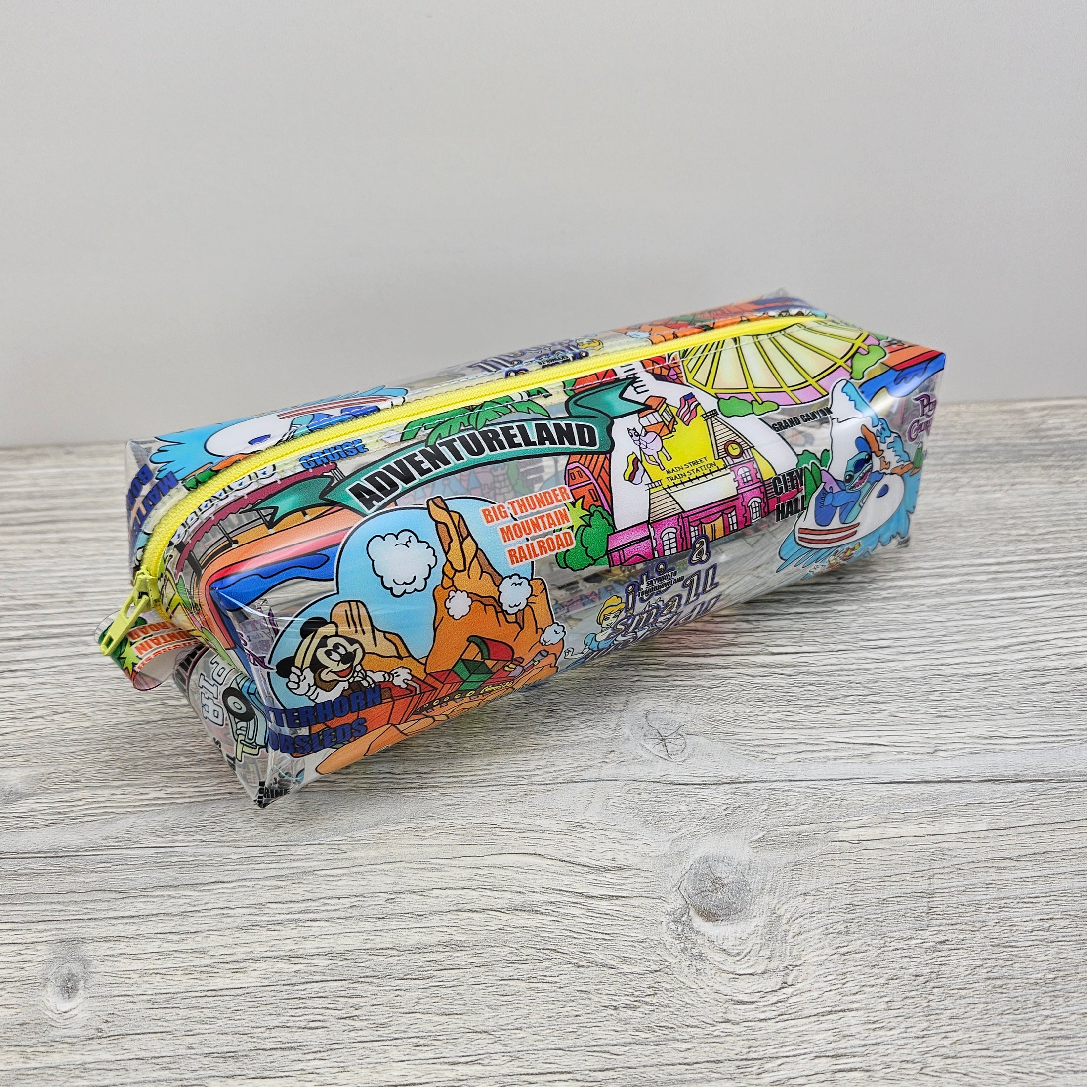 Clear vinyl zipper pouch with disney parks.