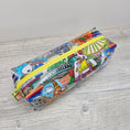 Load image into Gallery viewer, Clear vinyl pencil pouch with disney parks.
