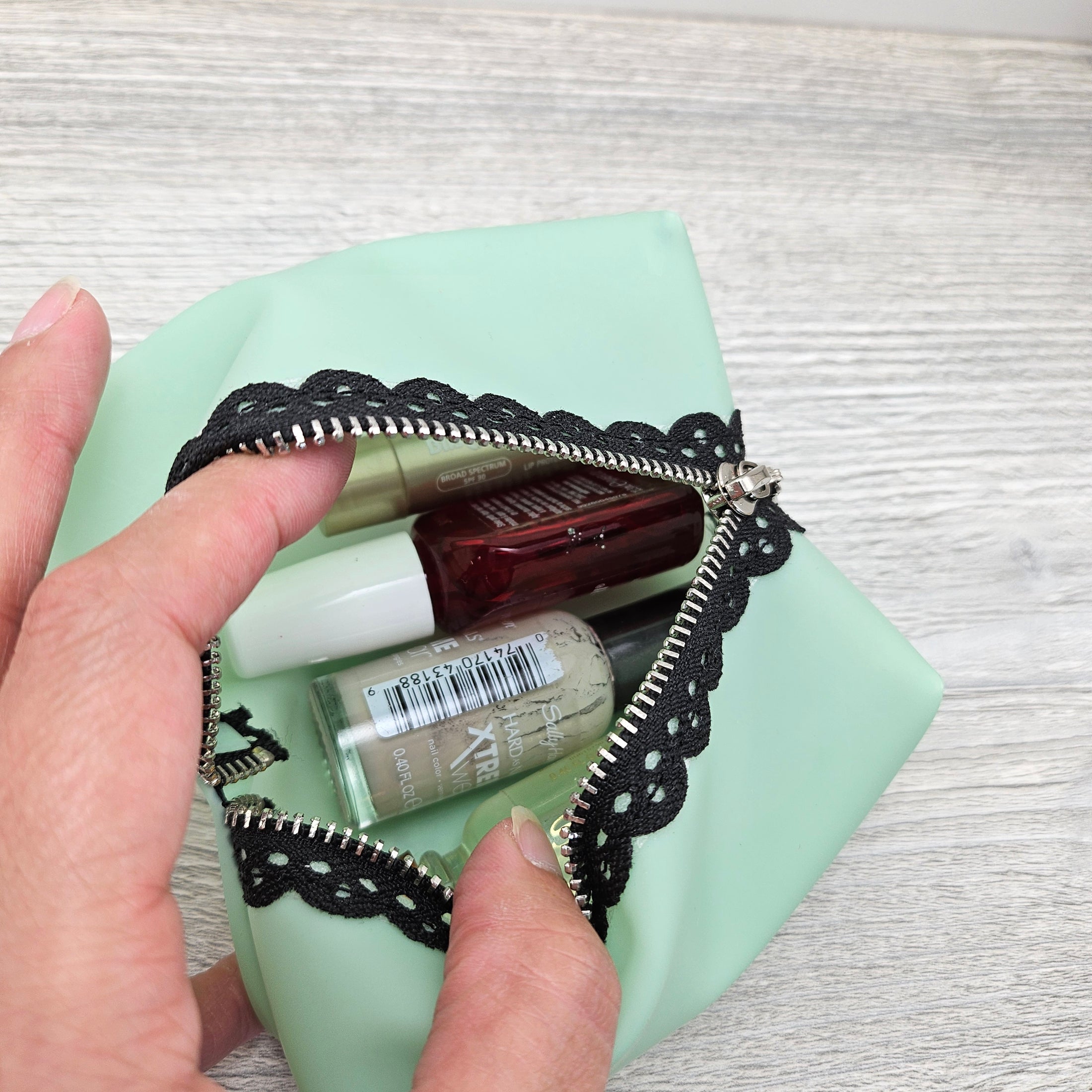 Mint green jelly vinyl boxy pouch for makeup.