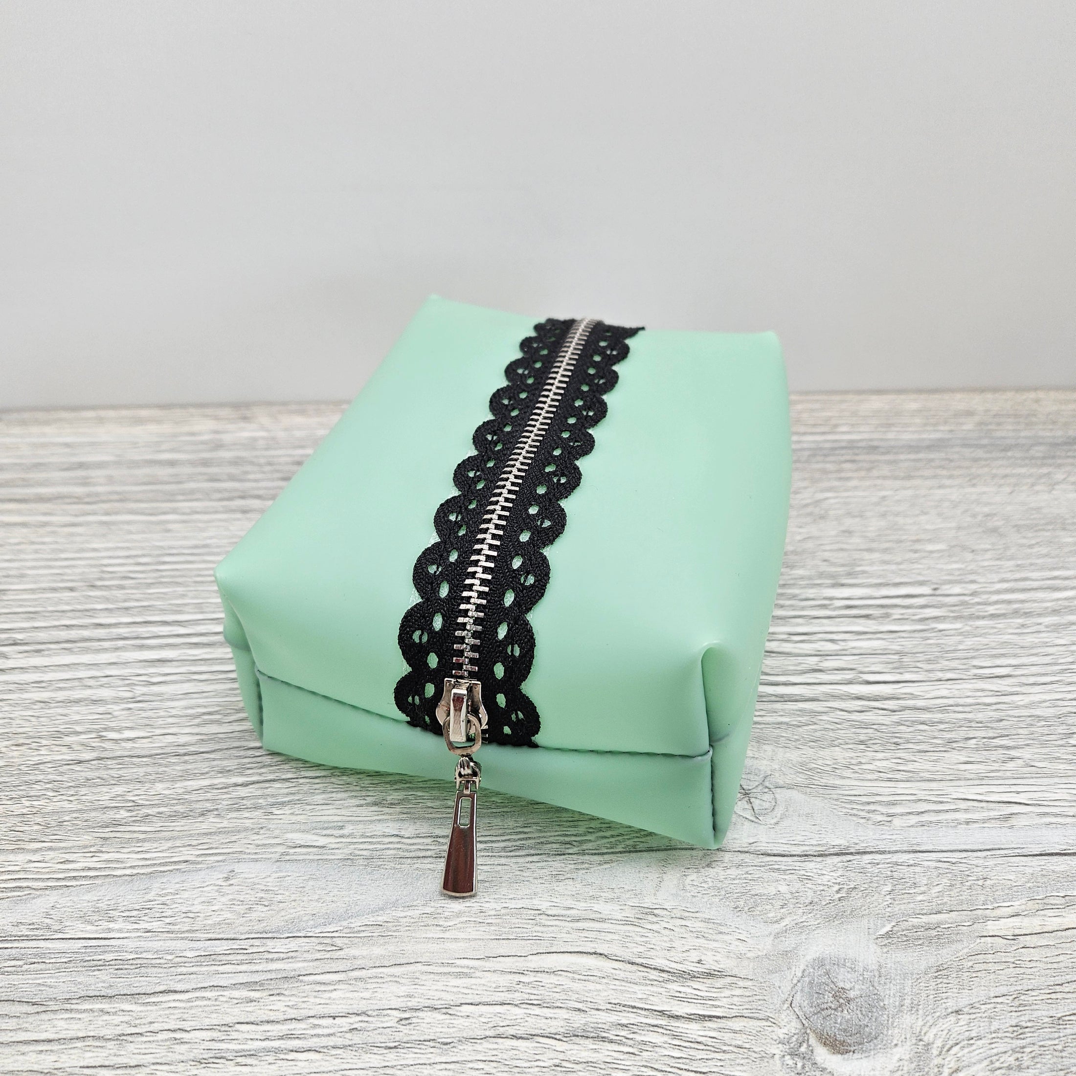 Mint green jelly vinyl boxy pouch.