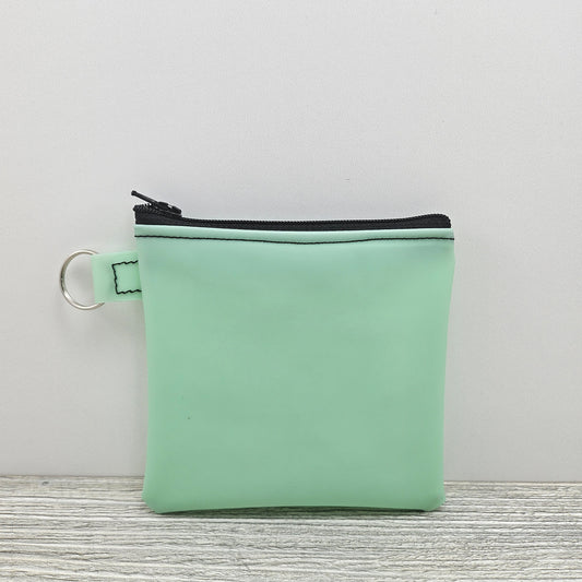 Mint green jelly vinyl small zipper pouch.