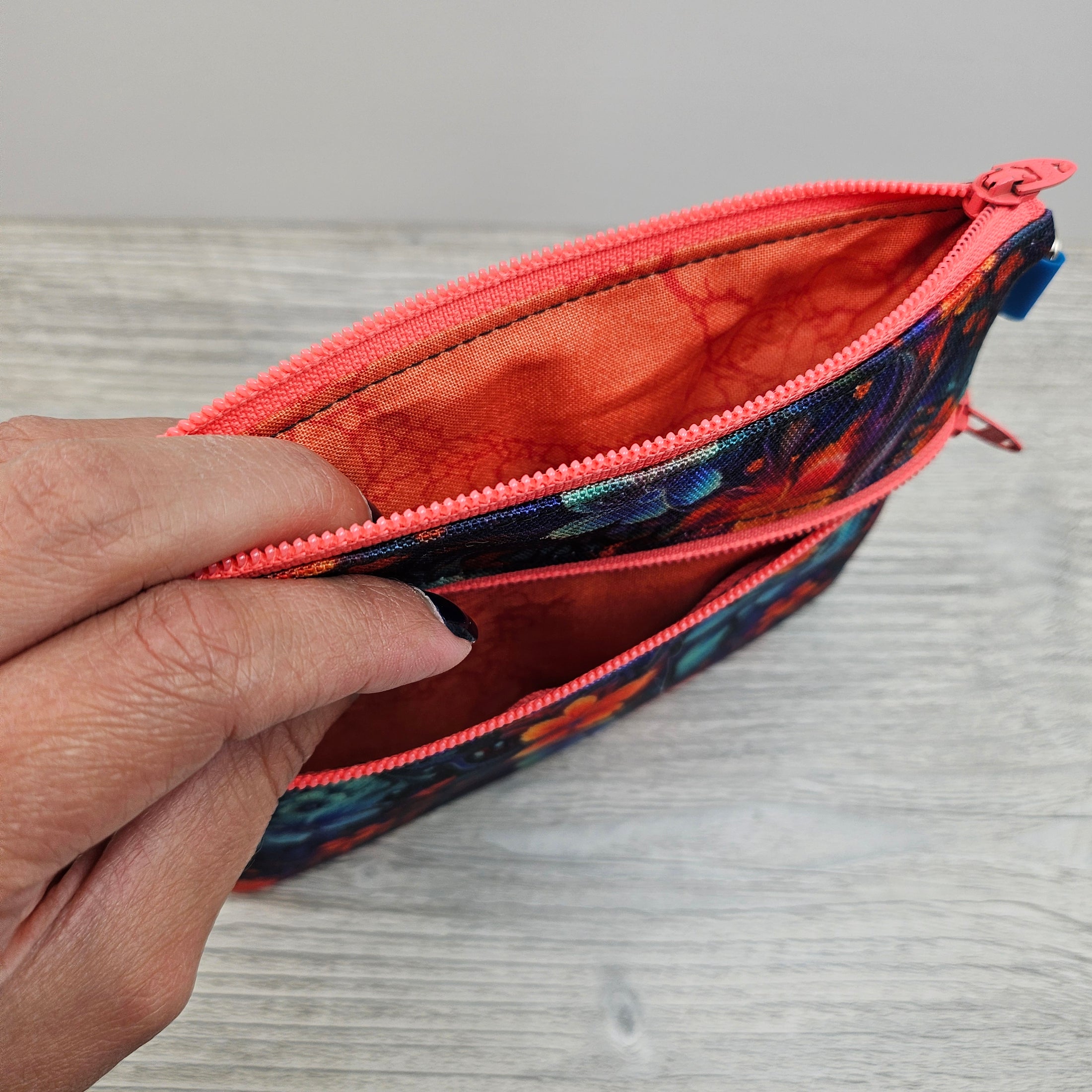 Cotton interior of the floral alien zipper pouch.