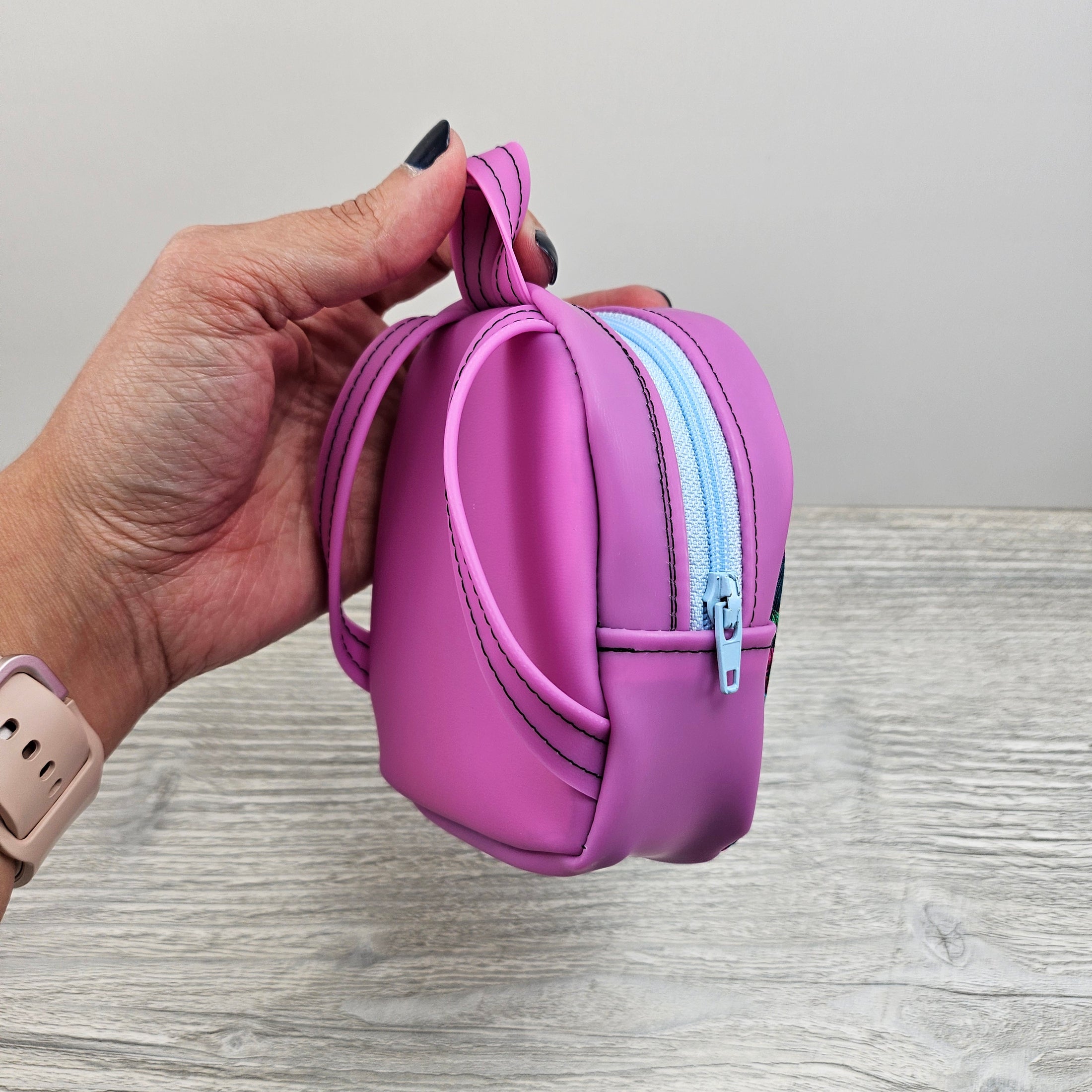 Purplish-pink mini backpack made with cotton and jelly vinyl.