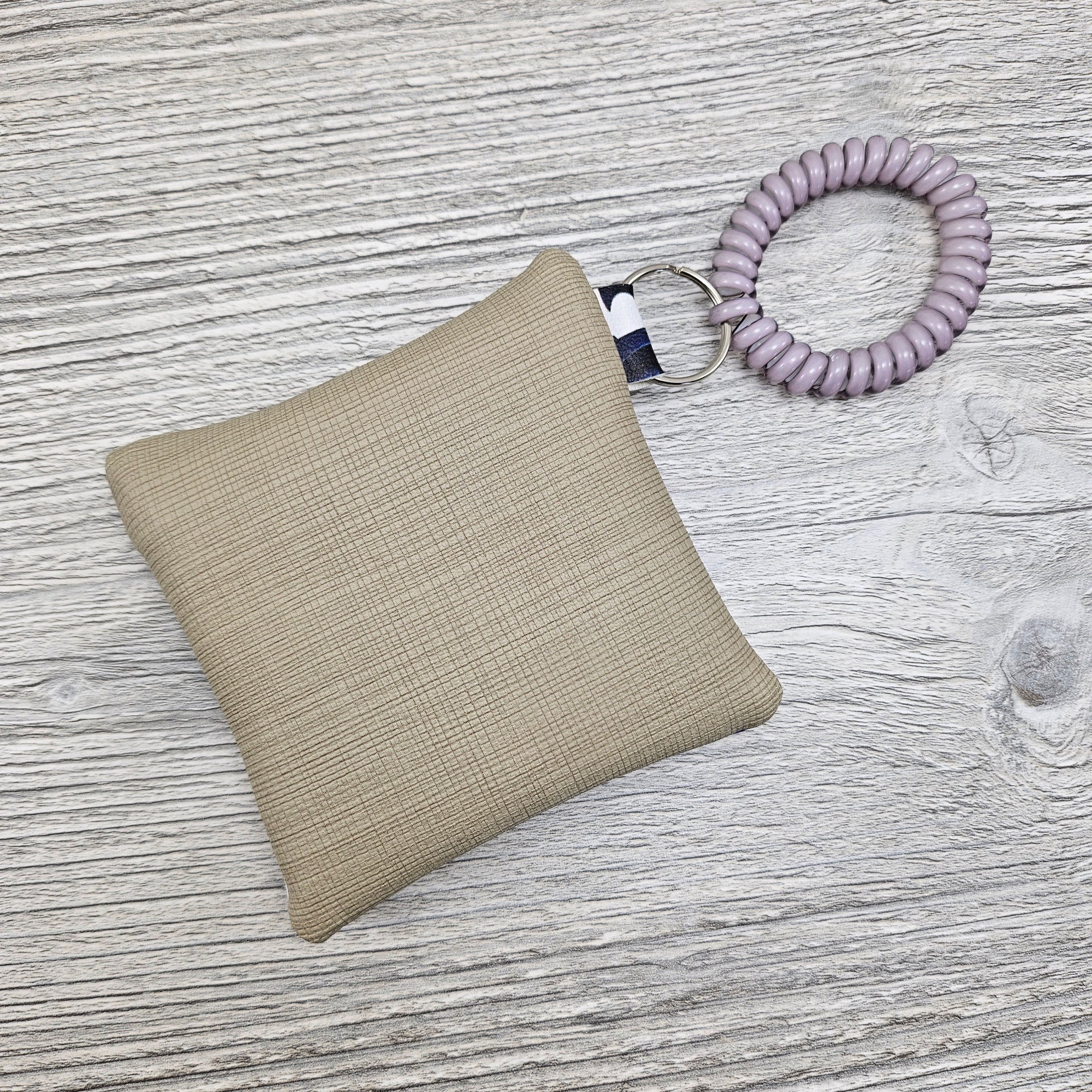 Beige back on the Wednesday Addams inspired mini wristlet pouch.