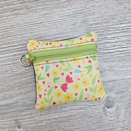 Mini spring flowers zipper pouch with d ring to attach to key ring. 