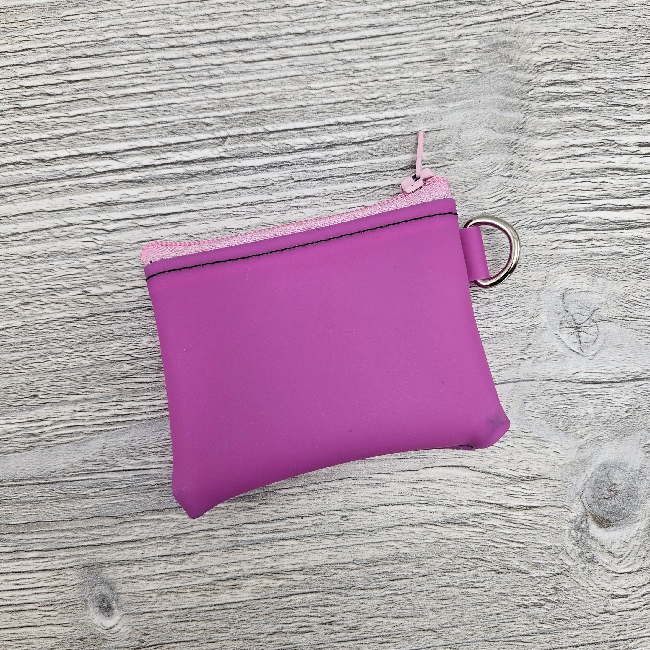 Mini pink jelly vinyl zipper pouch with d ring to attach to key ring. 