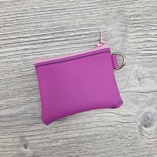 Mini pink jelly vinyl zipper pouch with d ring to attach to key ring. 