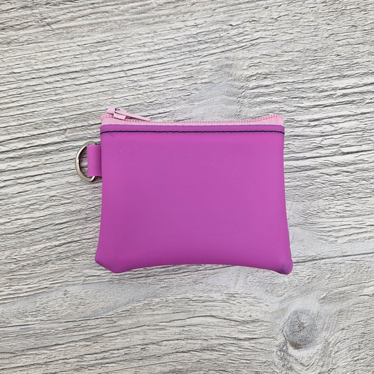 Mini pink jelly vinyl zipper pouch for coins and cash. 