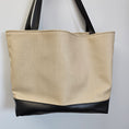 Load image into Gallery viewer, Beige and black tote bag with black handles.
