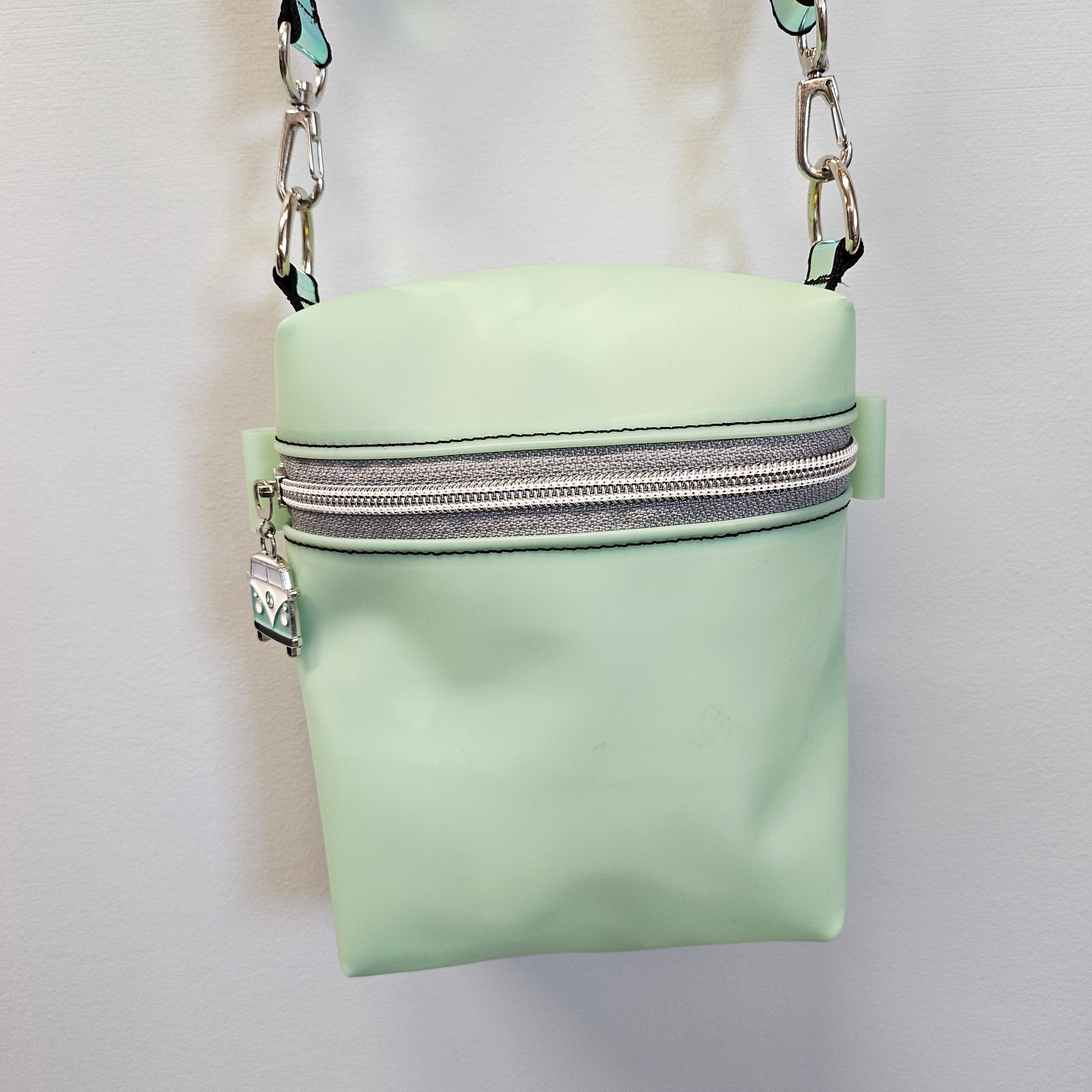 Mint green boxy bag with detachable strap.