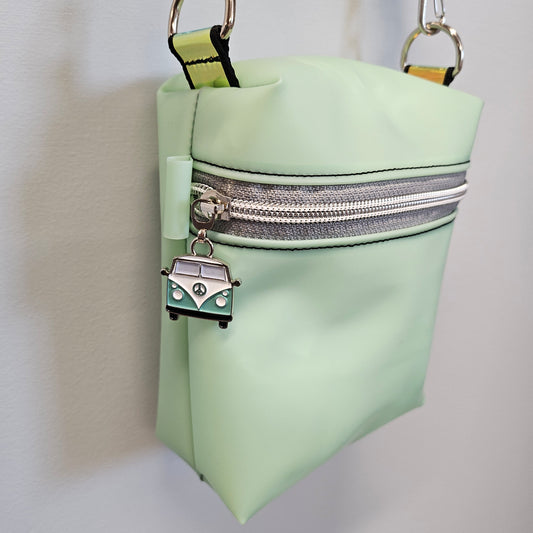 Mint green boxy bag with custom vw bus zipper pull.