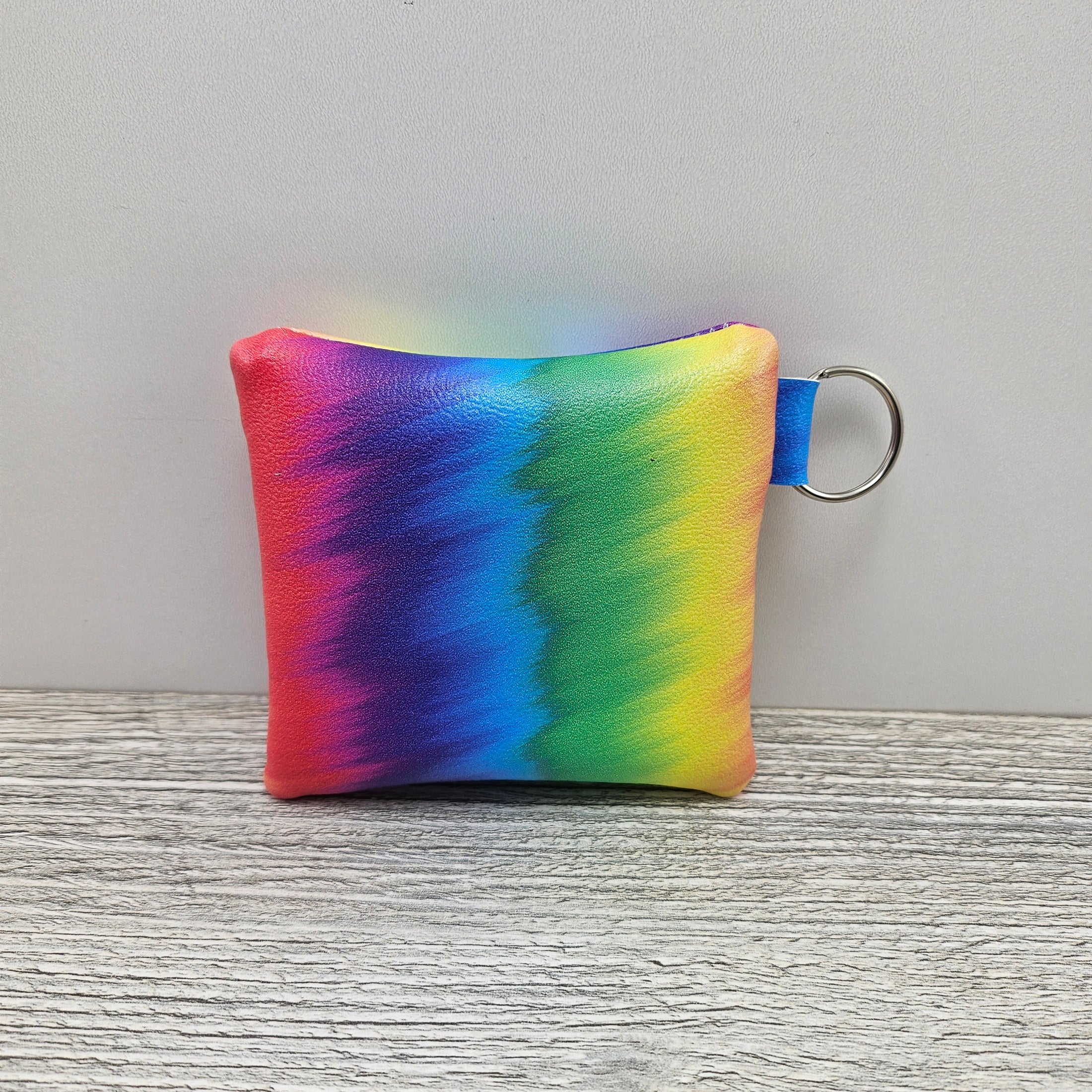 Mini rainbow accessory zipper pouch with key ring.