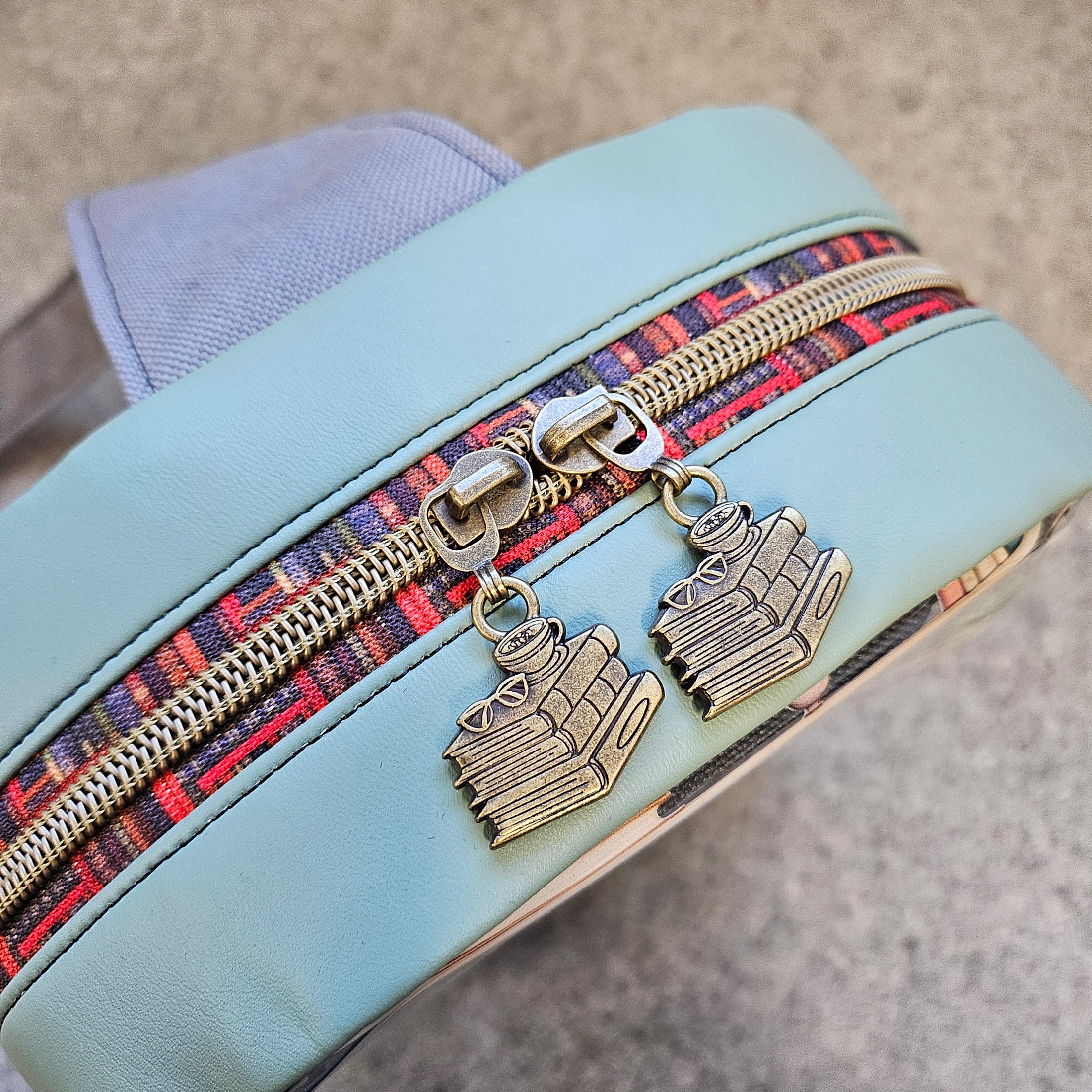 Book stack zipper pulls on the clear book lovers sling bag.