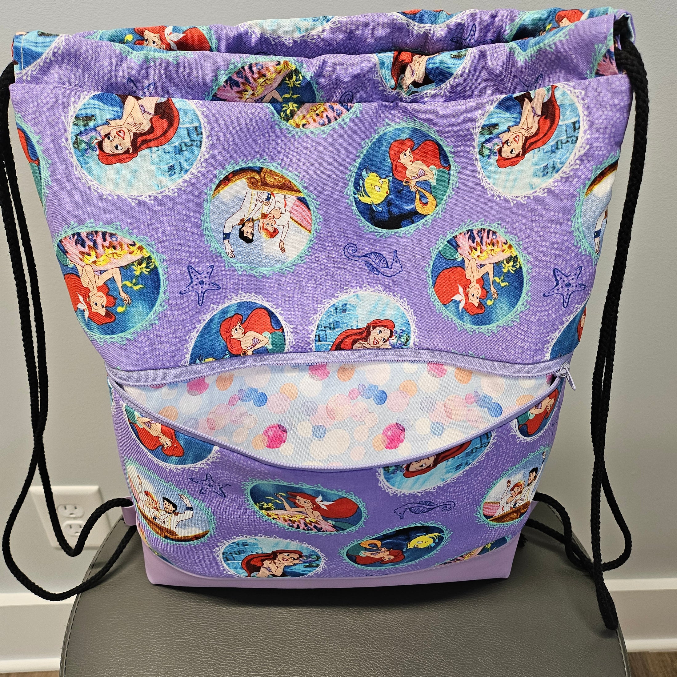Front pocket of The Little Mermaid drawstring backpack.