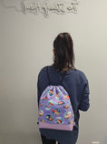Load image into Gallery viewer, Wearing The Little Mermaid drawstring backpack.
