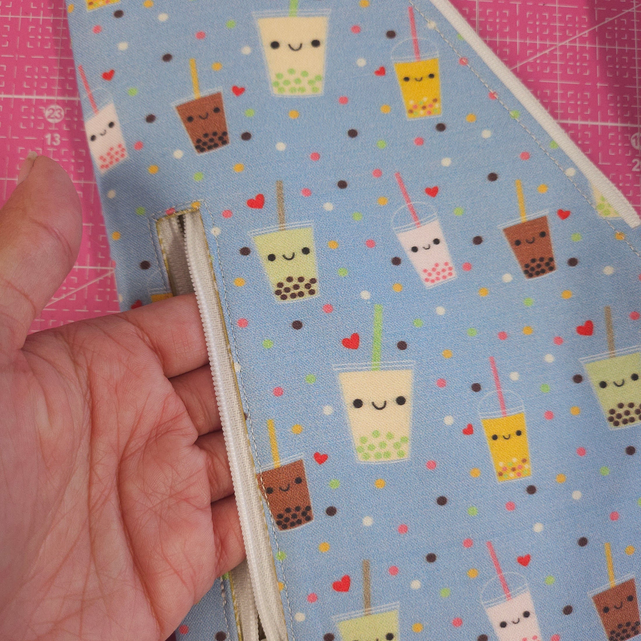 Bubble tea sling bag with exterior zipper pocket.