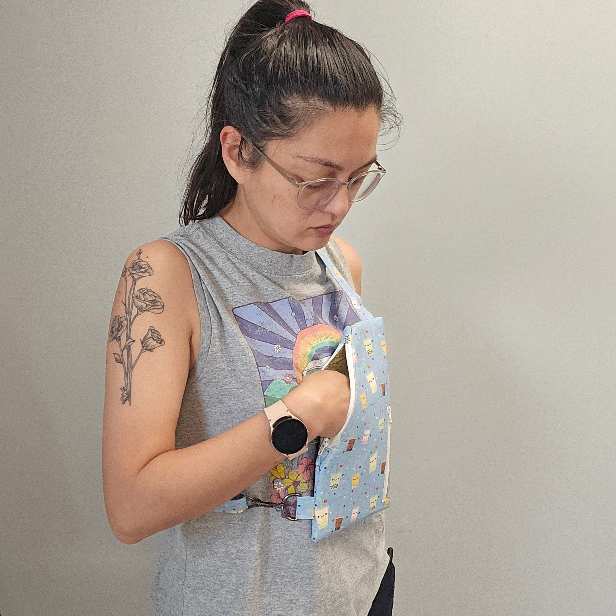 Person wearing the light blue bubble tea traveler sling bag on the front of their body.
