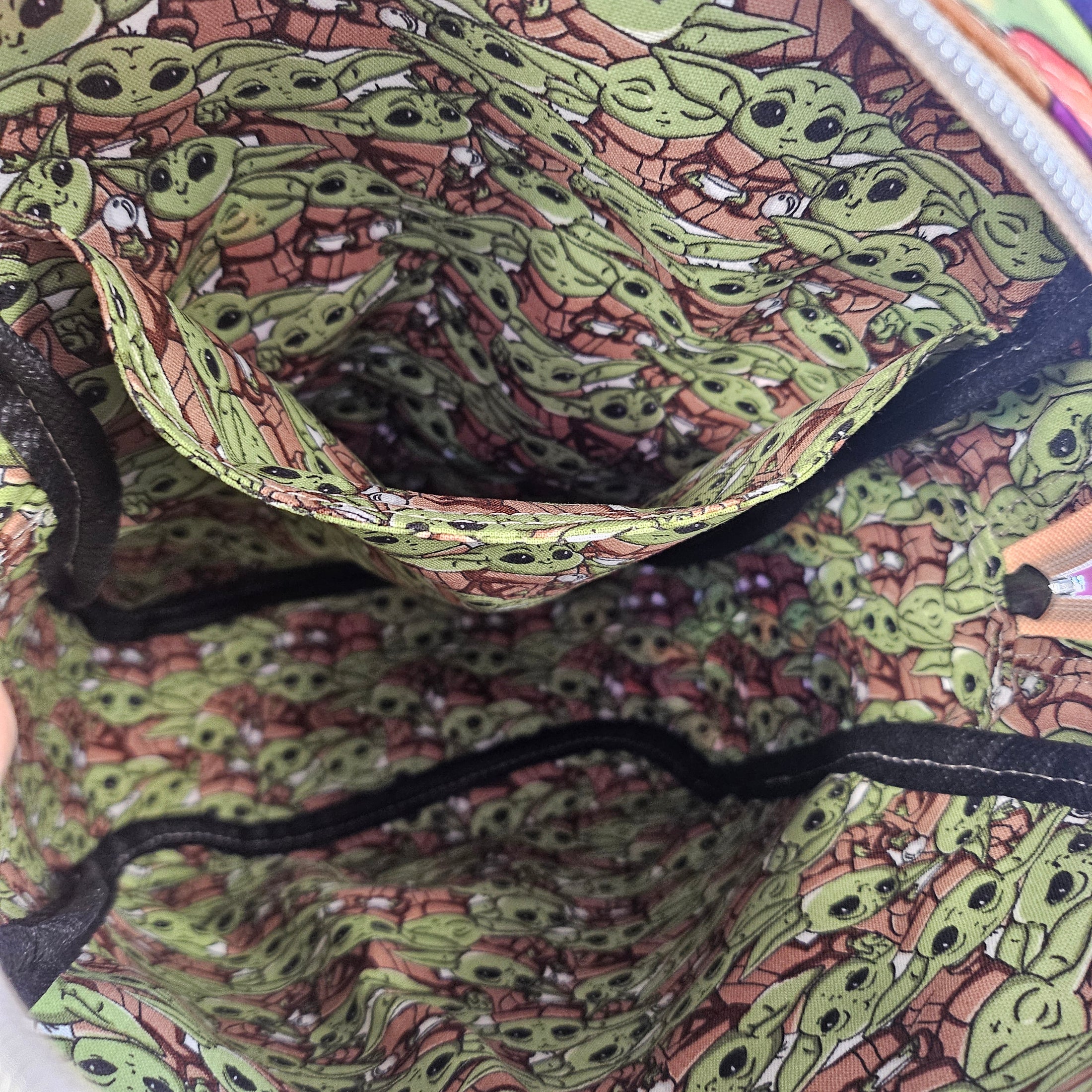 Interior slip pocket in the grogu crossbody sling bag.