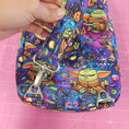 Load image into Gallery viewer, Strap connectors on the grogu inspired crossbody bag.

