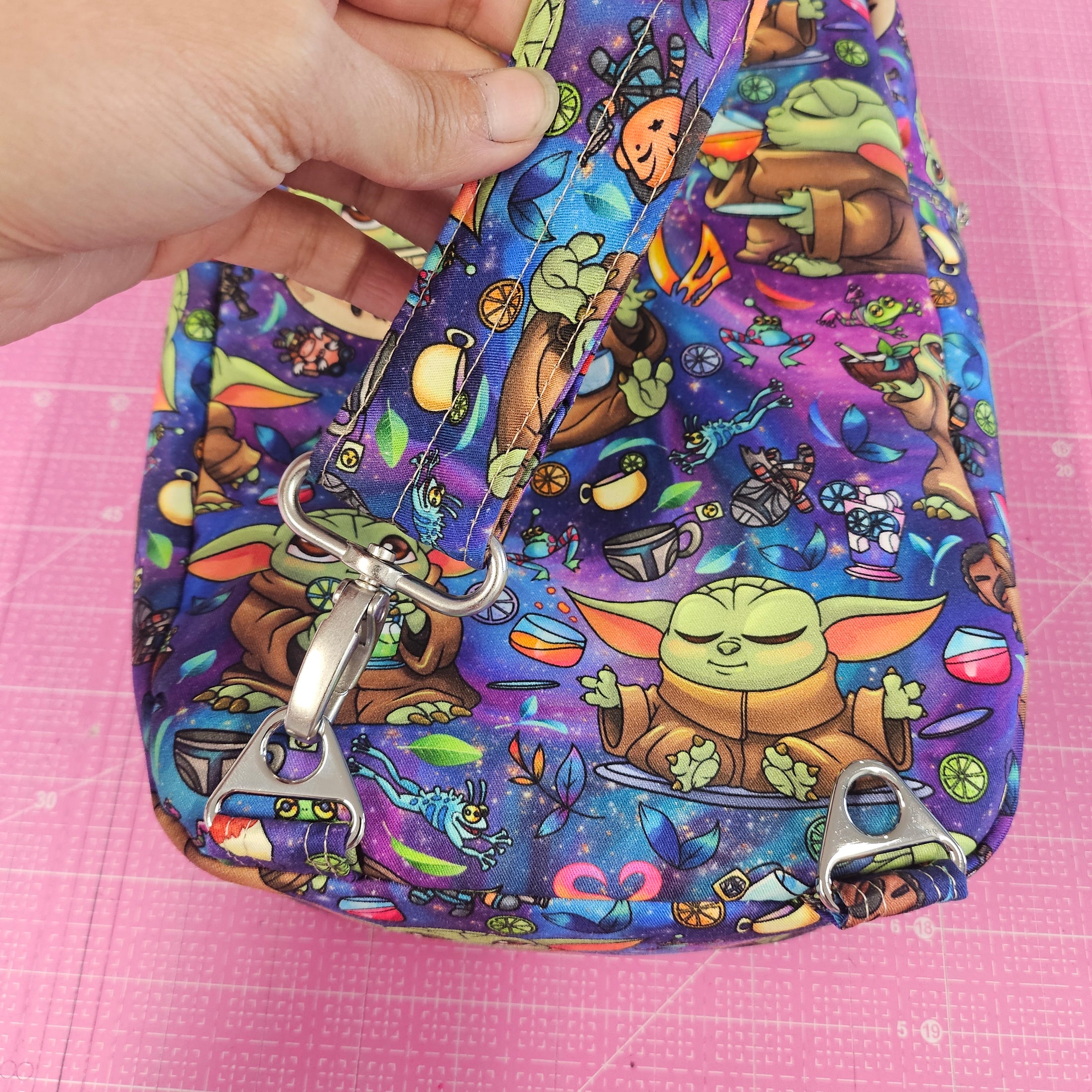 Strap connectors on the grogu inspired crossbody bag.