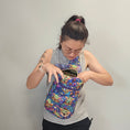 Load image into Gallery viewer, Person wearing the grogu crossbody bag on their front.
