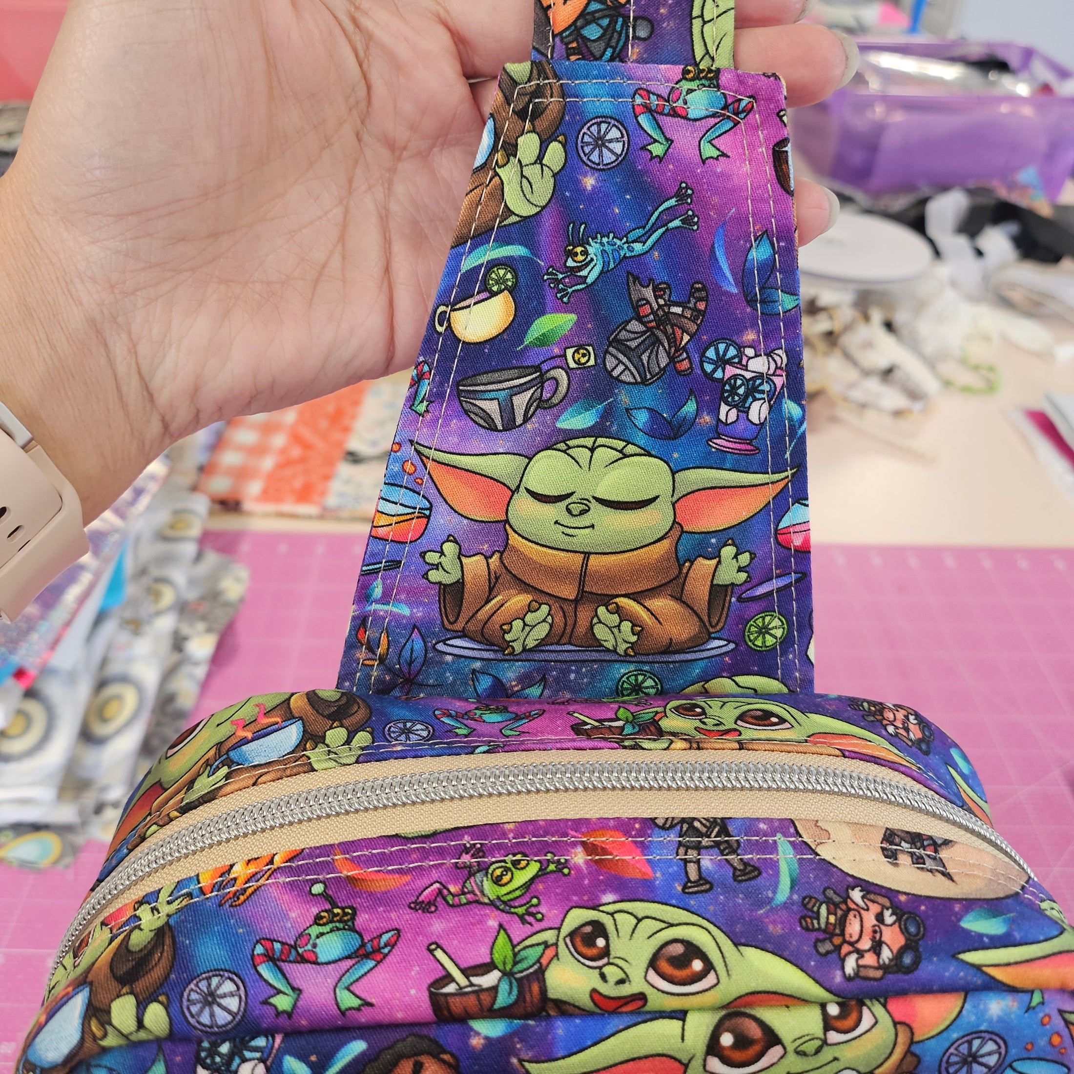 Grogu crossbody bag with images of Grogu sipping on drinks and meditating.