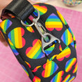 Load image into Gallery viewer, Crossbody bag with rainbow heart pattern on a pink background
