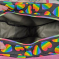 Load image into Gallery viewer, Black bag with rainbow heart pattern on a pink background
