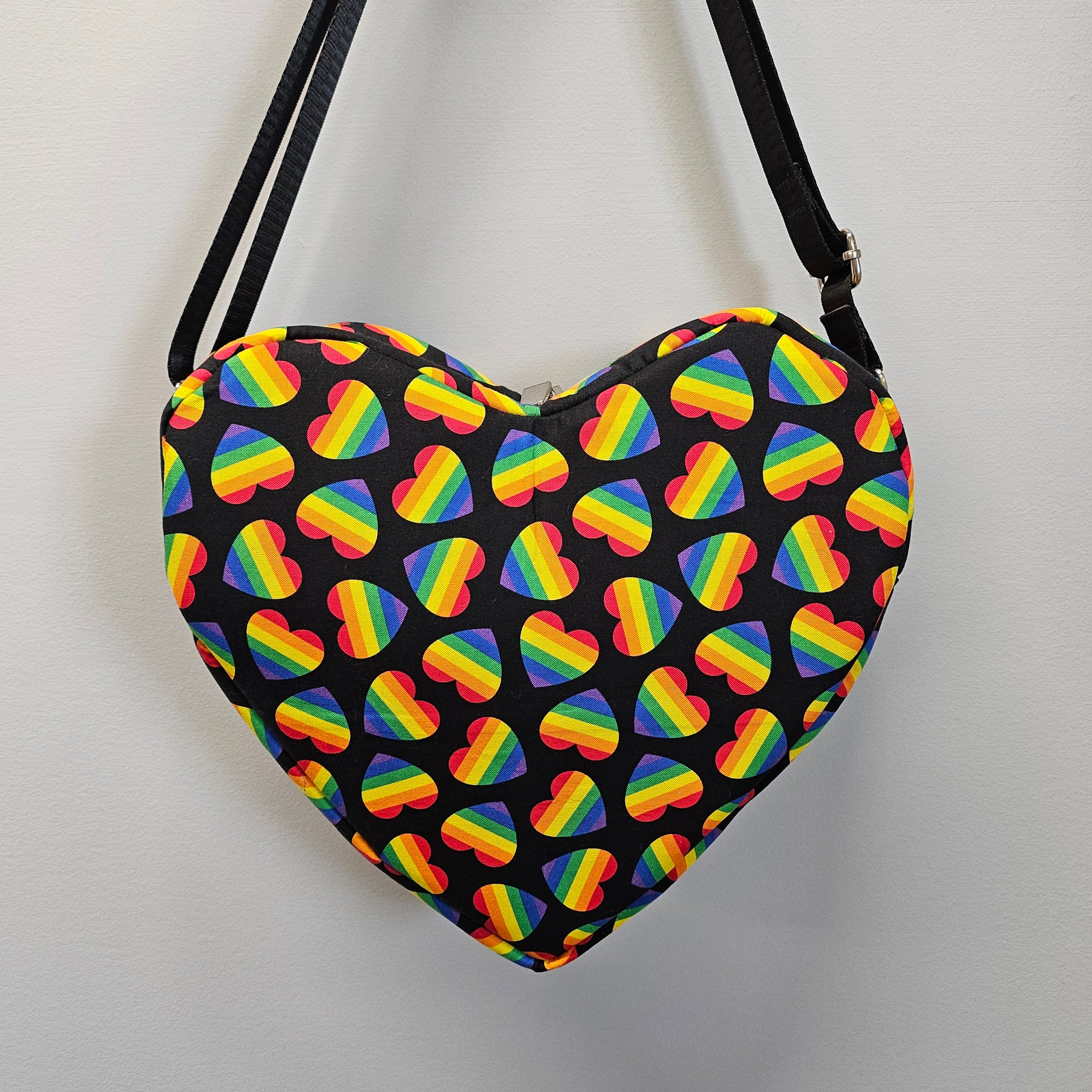 Bag with rainbow heart pattern on a black background