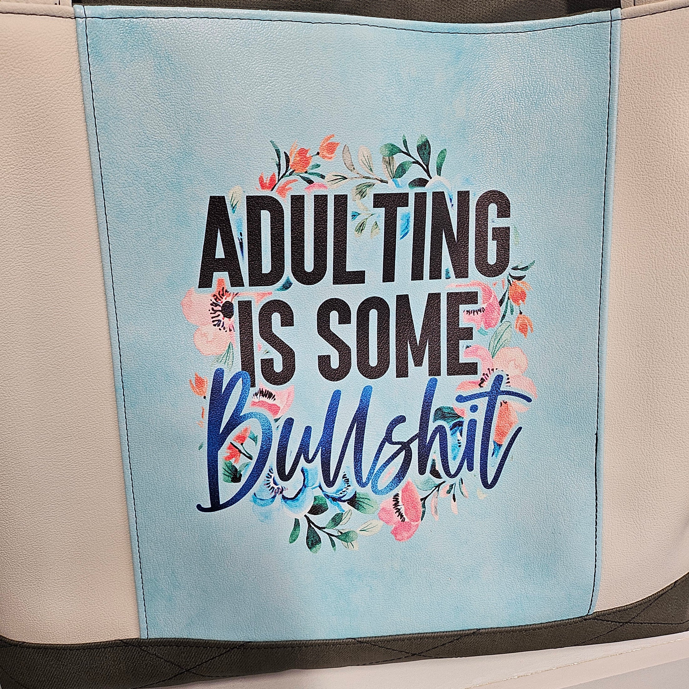 Text on a product with floral elements against a light blue background