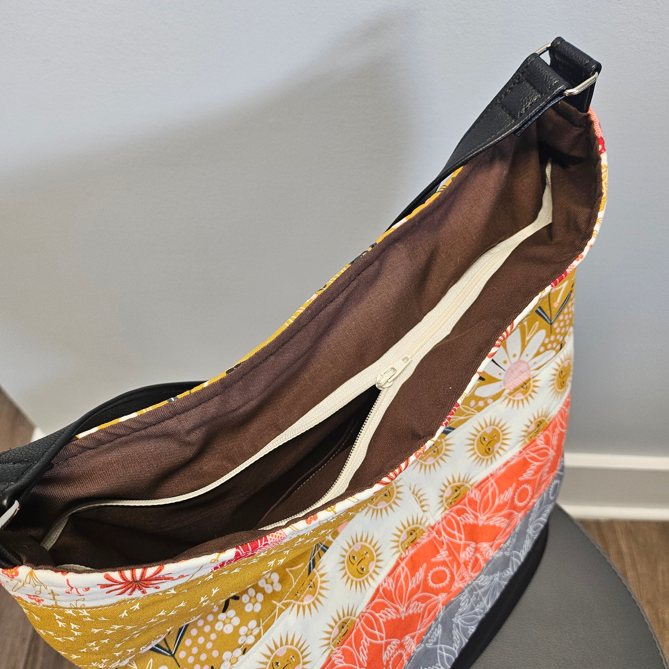 Close-up of a patterned bag with a brown interior on a plain background
