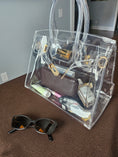 Load image into Gallery viewer, Clear crossbody purse sitting on a table.

