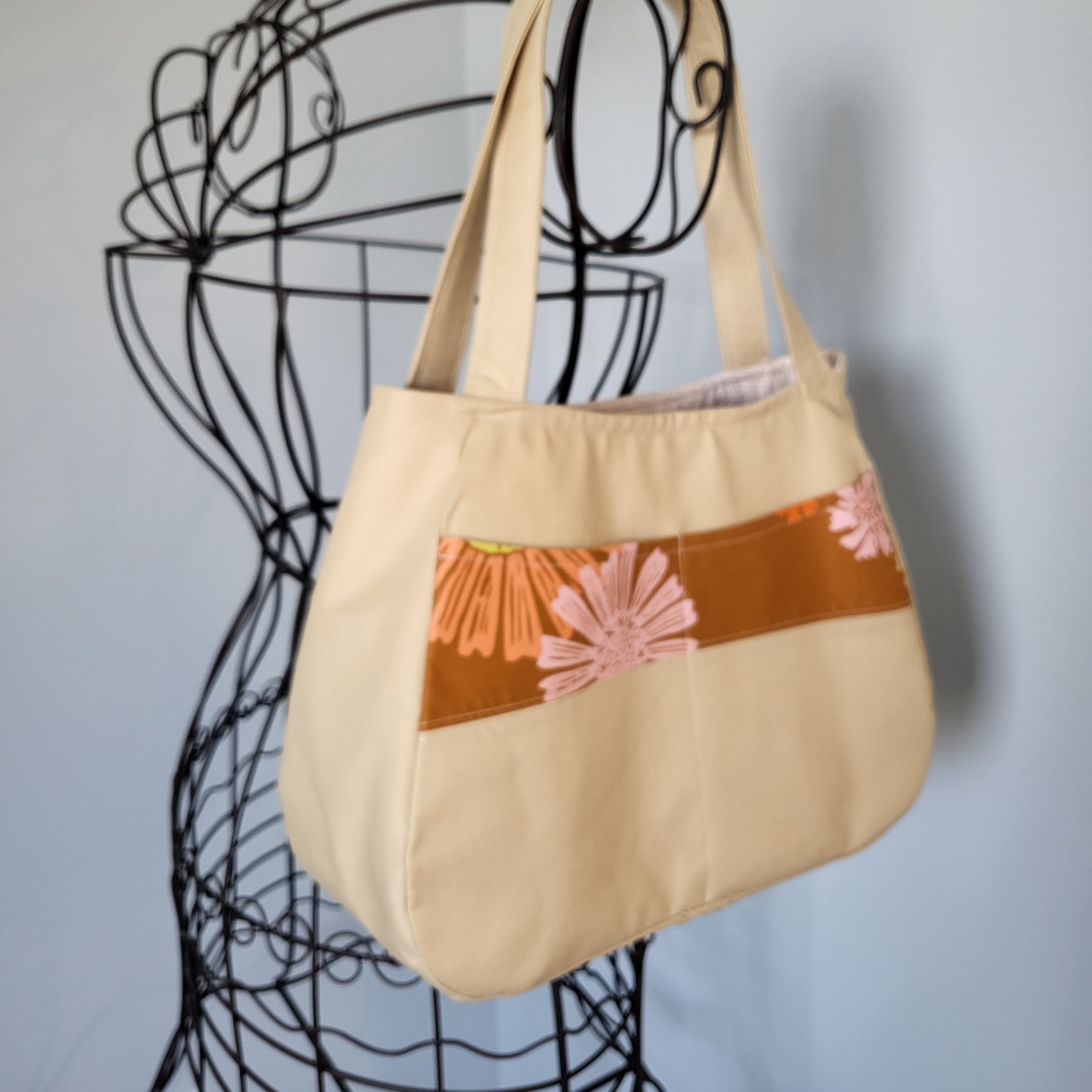 Exterior pockets of let the sunshine in tote bag. 