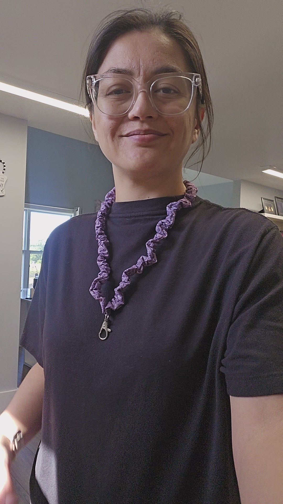 Short video of person showing off a purple skinny scrunchie lanyard.