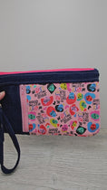 Load and play video in Gallery viewer, Video of the we rise by lifting others zippy clutch.
