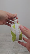 Load and play video in Gallery viewer, Video of green and cream pet bag holder. 
