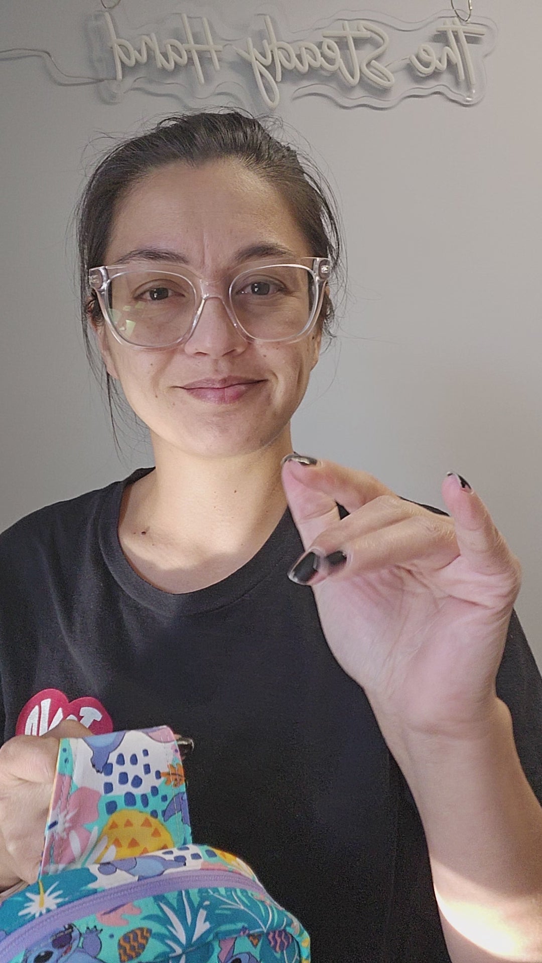 Video of person showing off the disney stitch inspired sling bag.