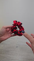 Load and play video in Gallery viewer, Video of the red with black polka dots scrunchie.
