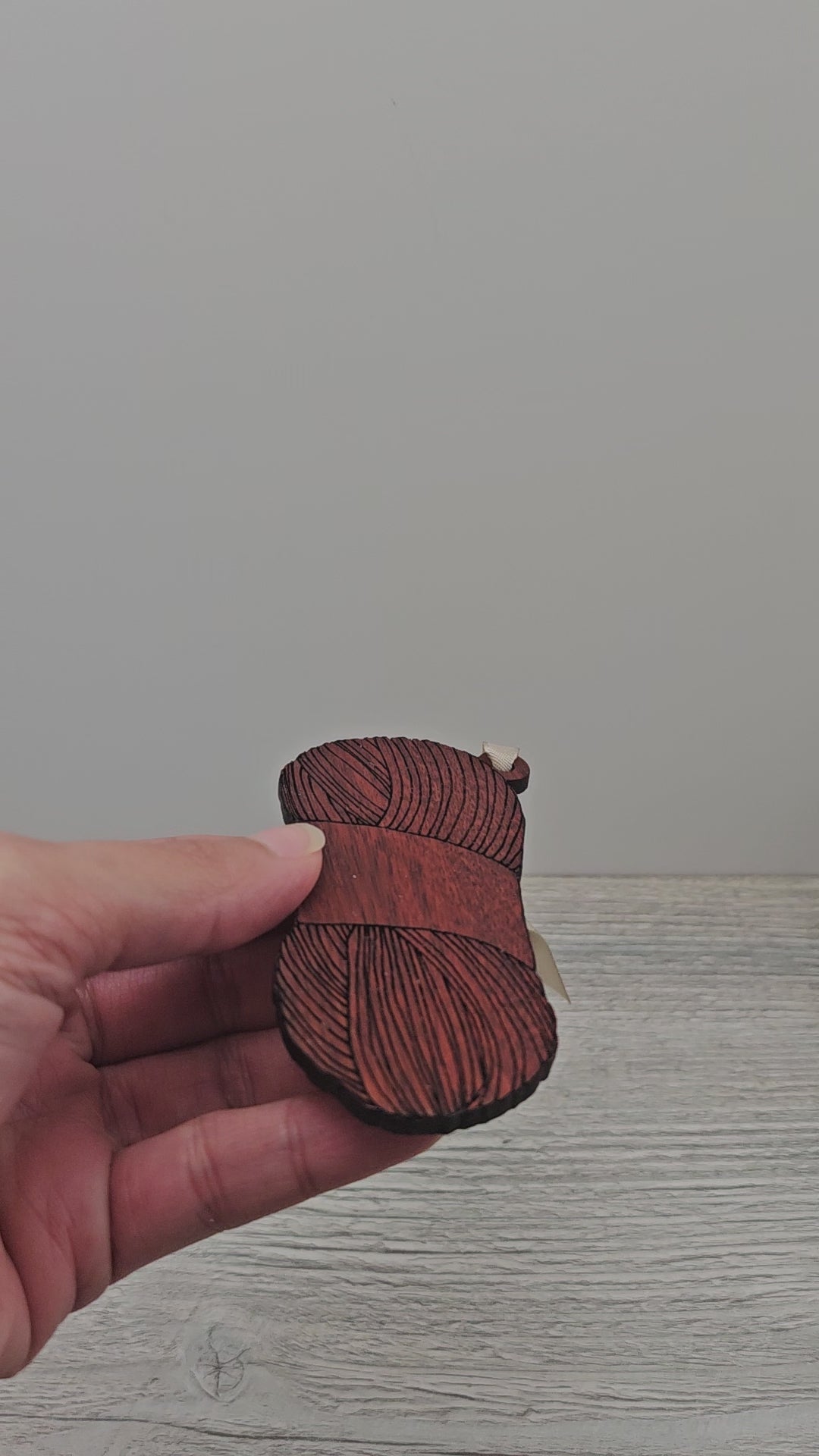 Video of laser cut and engraved yarn skein ornament made from exotic bloodwood.