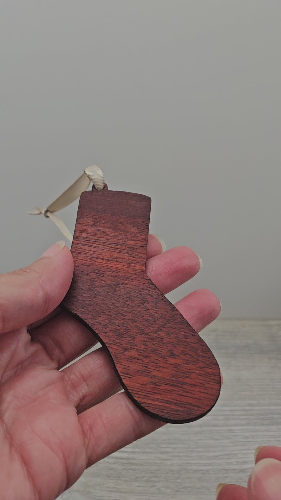 Video of sock ornament laser cut from exotic bloodwood.