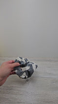 Load and play video in Gallery viewer, Video of the gray and white scrunchie. 
